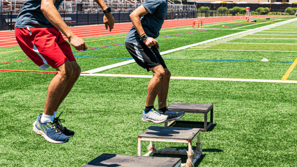 Athletes performing step up exercises on turf with colorful markings