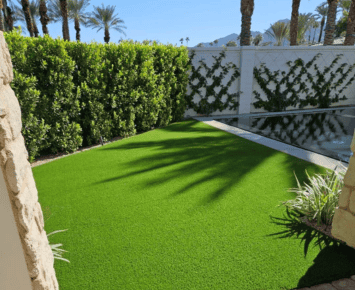 Commercial 14 commercial artificial grass installed on soil creating a vibrant and low maintenance outdoor area with natural landscaping elements