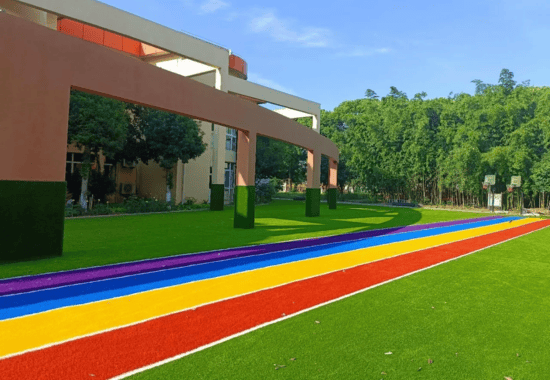 Custom Turf 9 custom artificial grass installation with vibrant rainbow pattern ideal for playgrounds and creative outdoor spaces