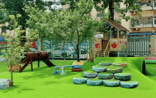 Playground 13 playground turf with colorful play structures including tire steps and a slid