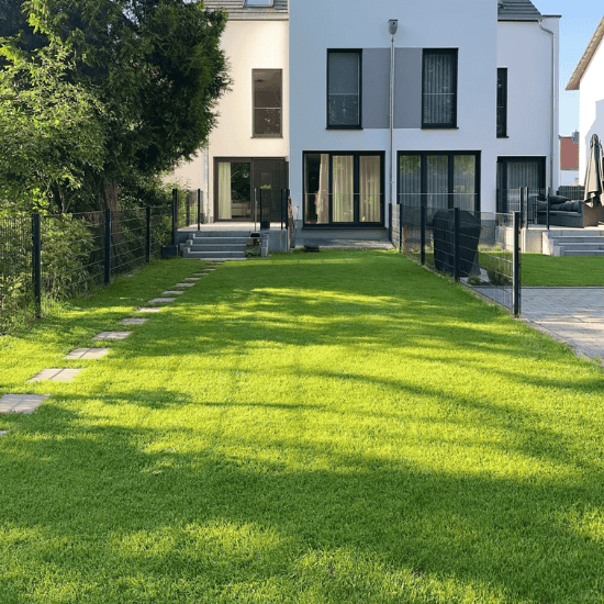 Residential 1 residential artificial grass in backyard providing low maintenance lush green space