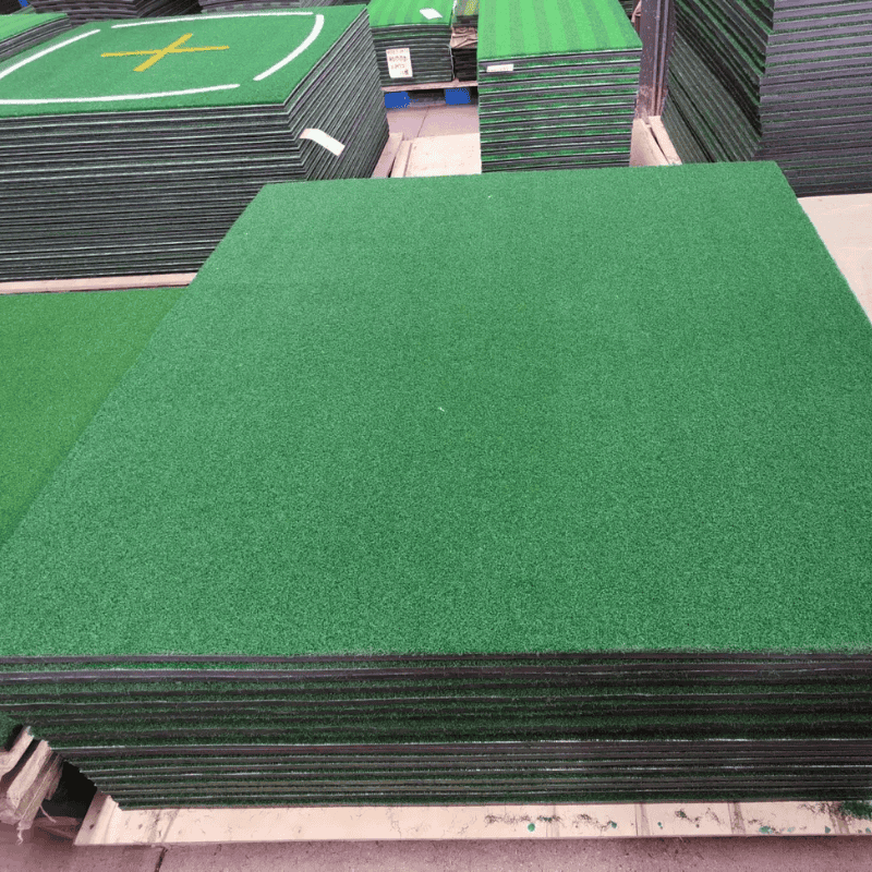 Indoor 12 stack of synthetic turf mats in warehouse ready for installation in golf courses or sports fields