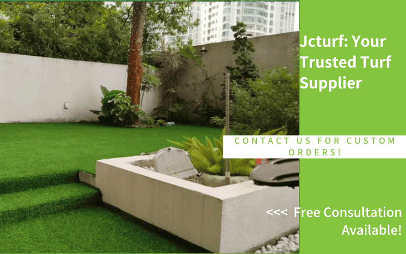 landscaped outdoor space with synthetic turf and garden bed creating a neat and clean appearance