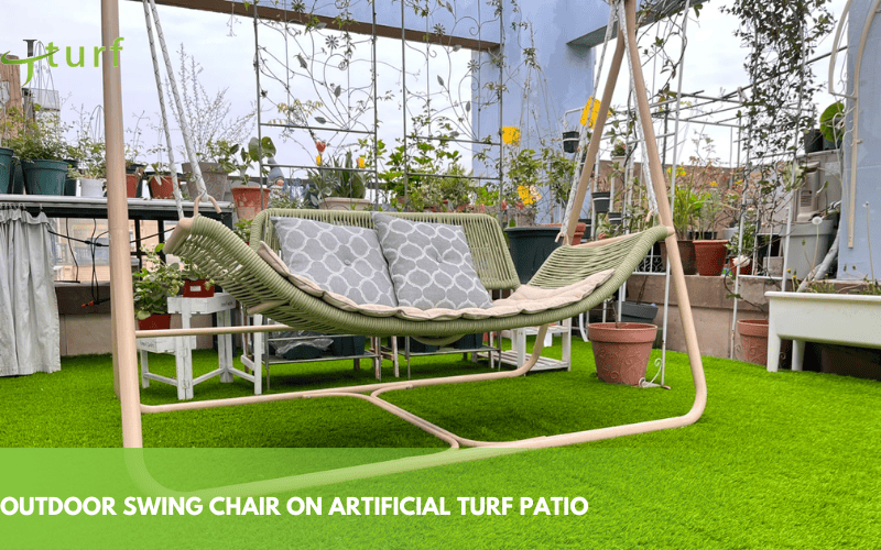 23 Inspiring Fake Grass Patio Ideas for a Beautiful, Low-Maintenance Patio 7 outdoor swing chair on synthetic grass with plants around perfect for relaxing in a patio