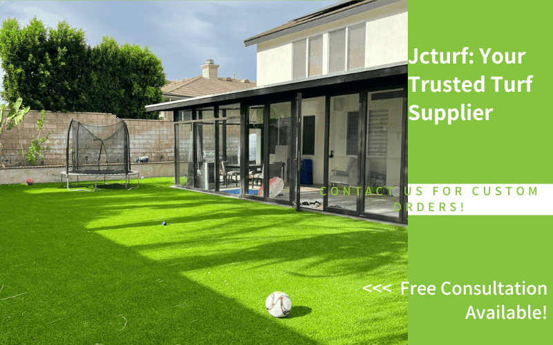 Residential backyard with artificial turf and children's toys on the lawn
