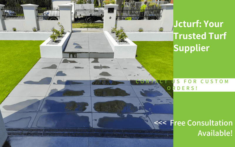 artificial grass and stone path entryway with branding
