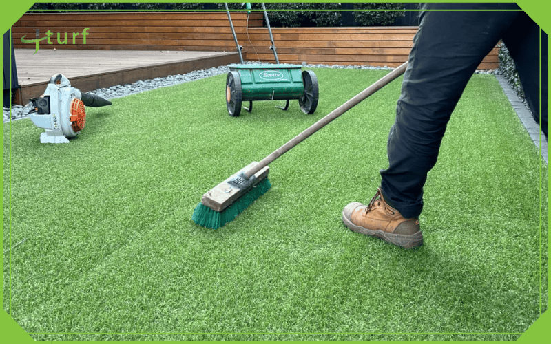 brushing artificial grass blades for even finish