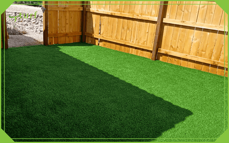 fenced patio area covered with artificial grass lawn