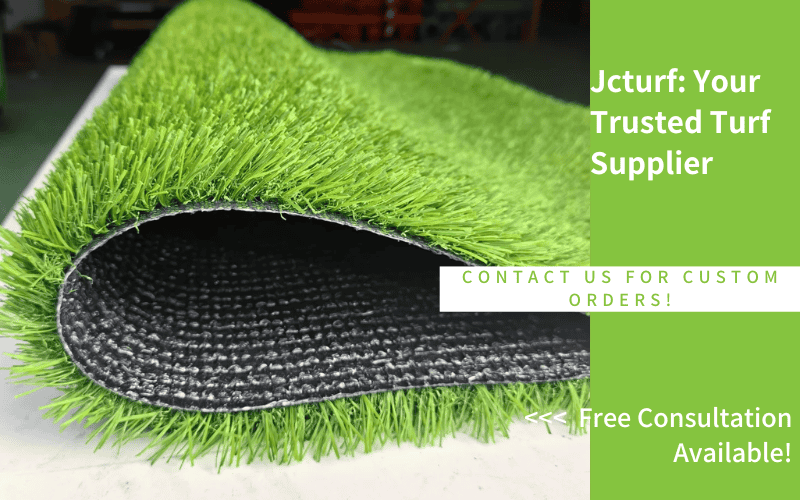 A close-up of rolled artificial turf with vibrant green blades, showcasing its texture and quality against a dark backing.
