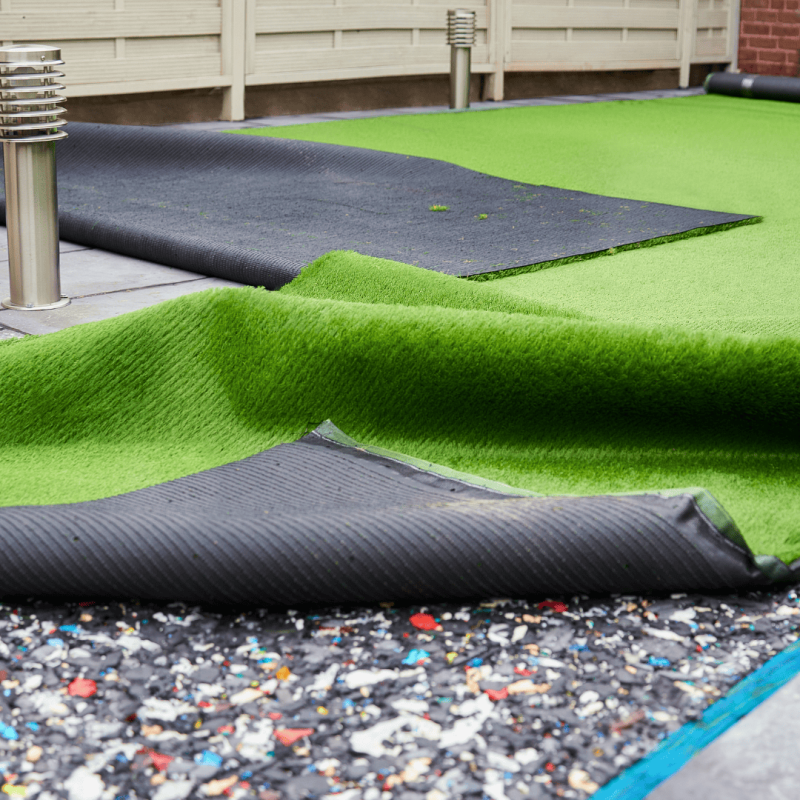 Pet turf installation in progress showing layered materials and synthetic grass Pet turf installation in progress showing layered materials and synthetic grass